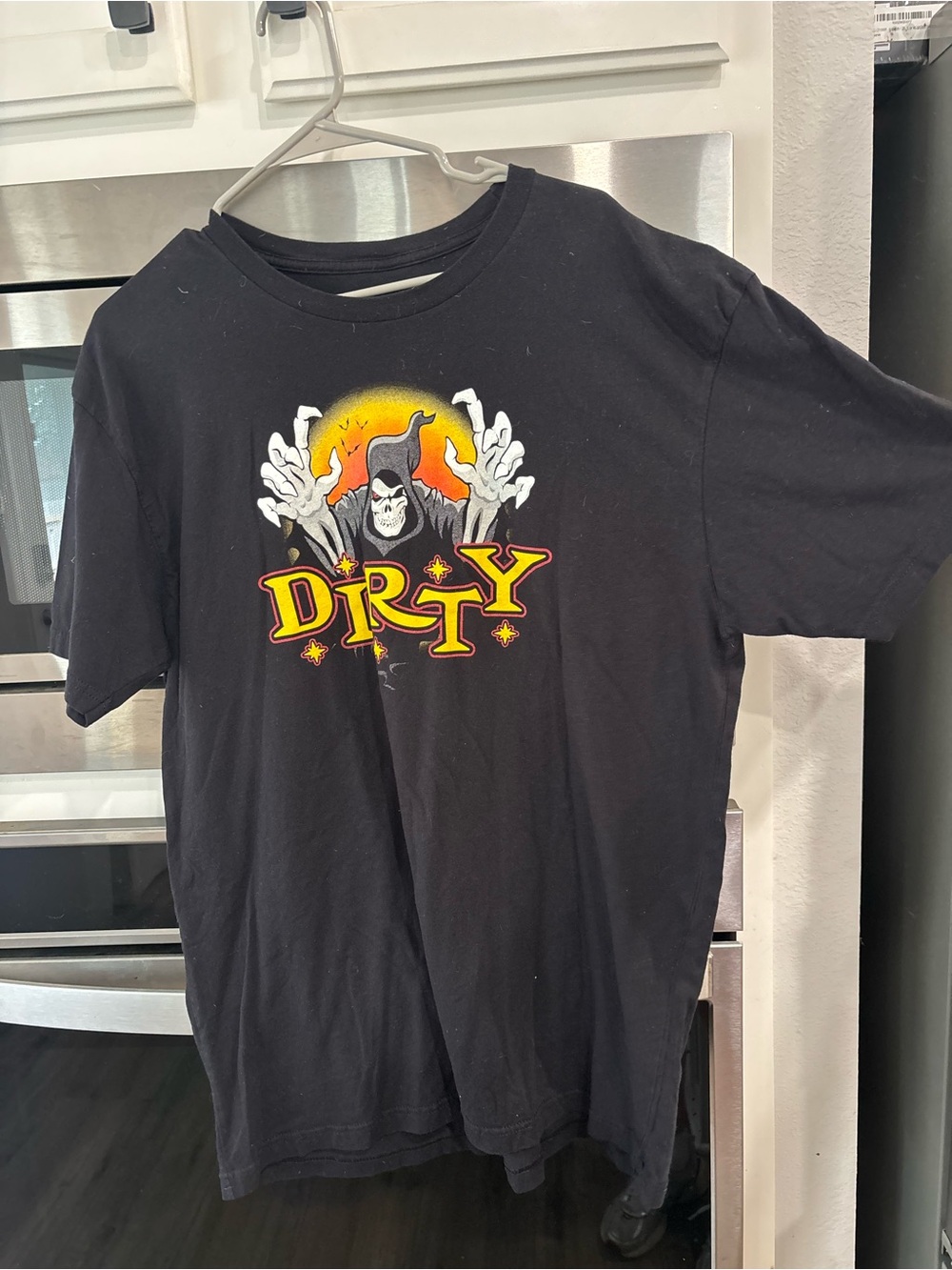 Black Graphic Tee with Yellow-Orange 'DIRTY' Skull Design